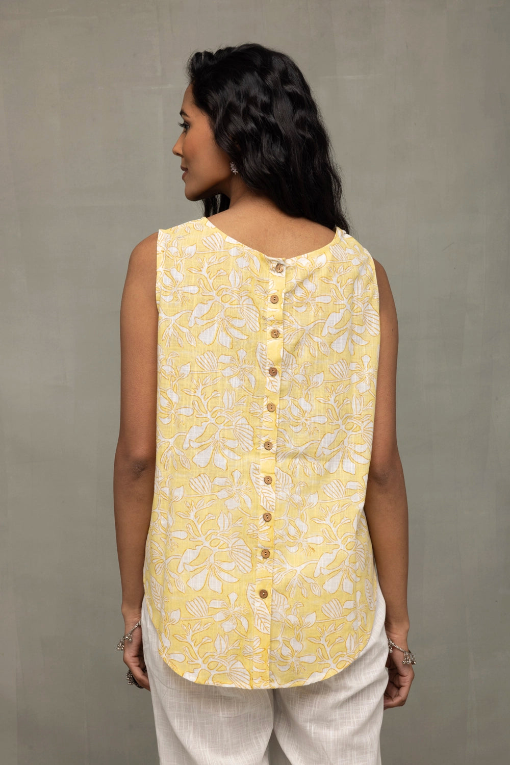 Back View of Sunshine Yellow Top Showcasing White Print and Buttoned Back Pattern