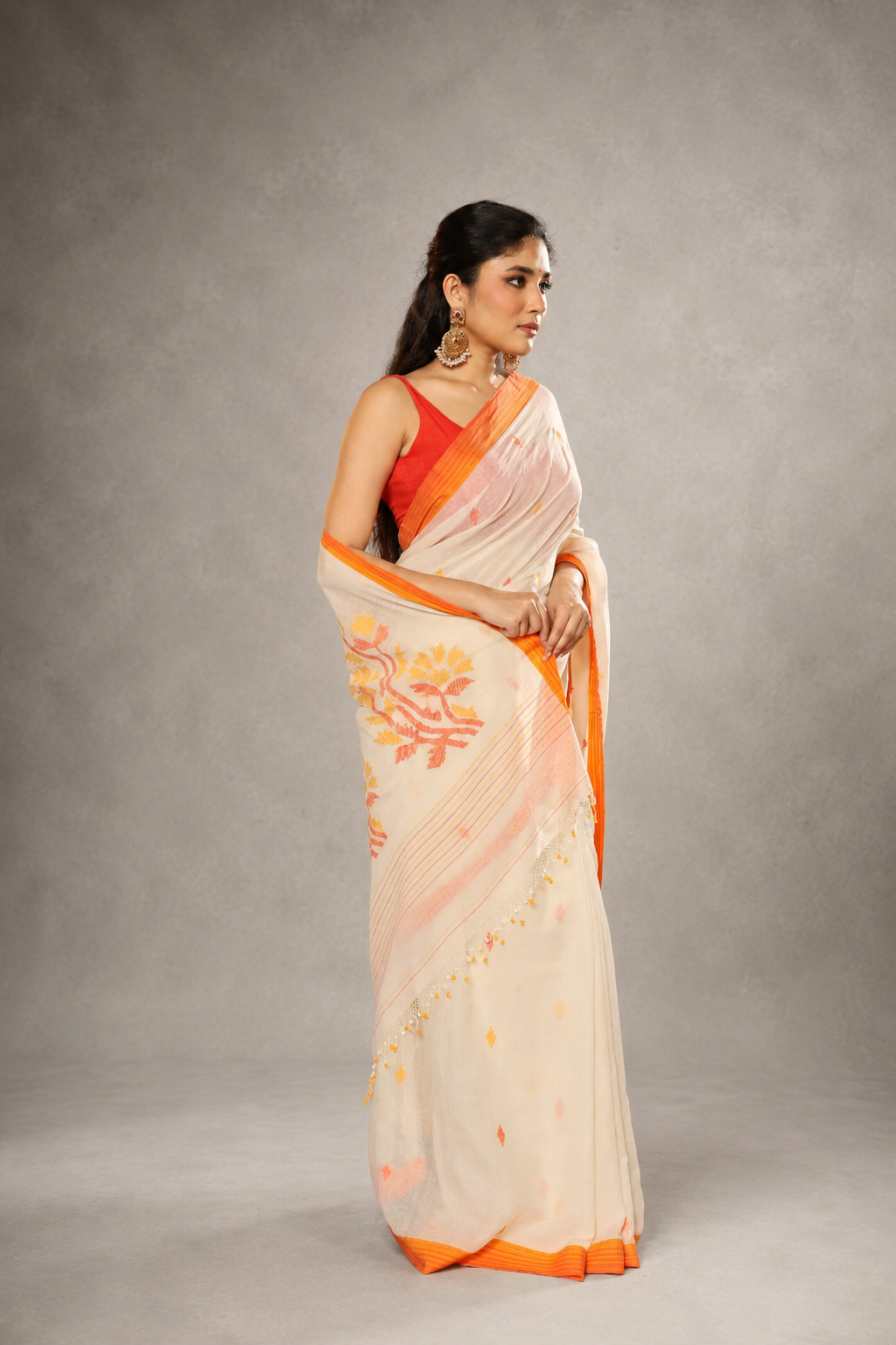 Front view of off-white and orange floral Jamdani saree